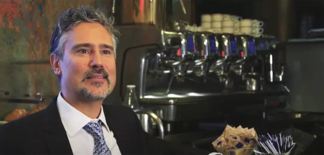 Man infront of coffee machine 