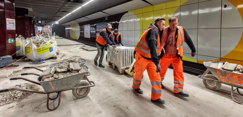 Construction workers moving a heavy load