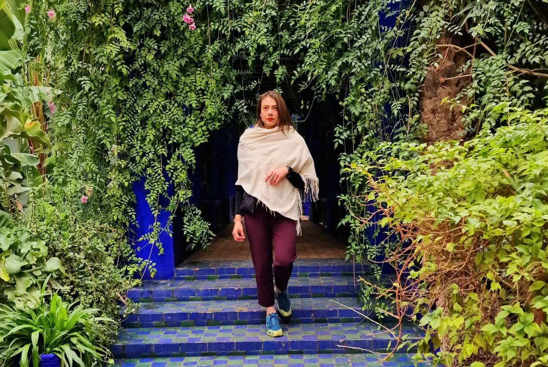 Woman walking down the stairs; Trees shown on the side