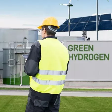 Mann Steht vor Anlage mit grünem H2, Vorprodukt von eFuels