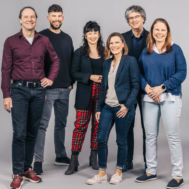 Portrait shot of colleagues from the graphics department smiling at the camera
