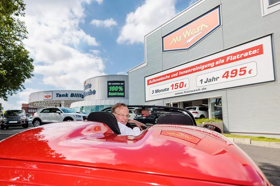 Man driving his car towards Mr.Wash