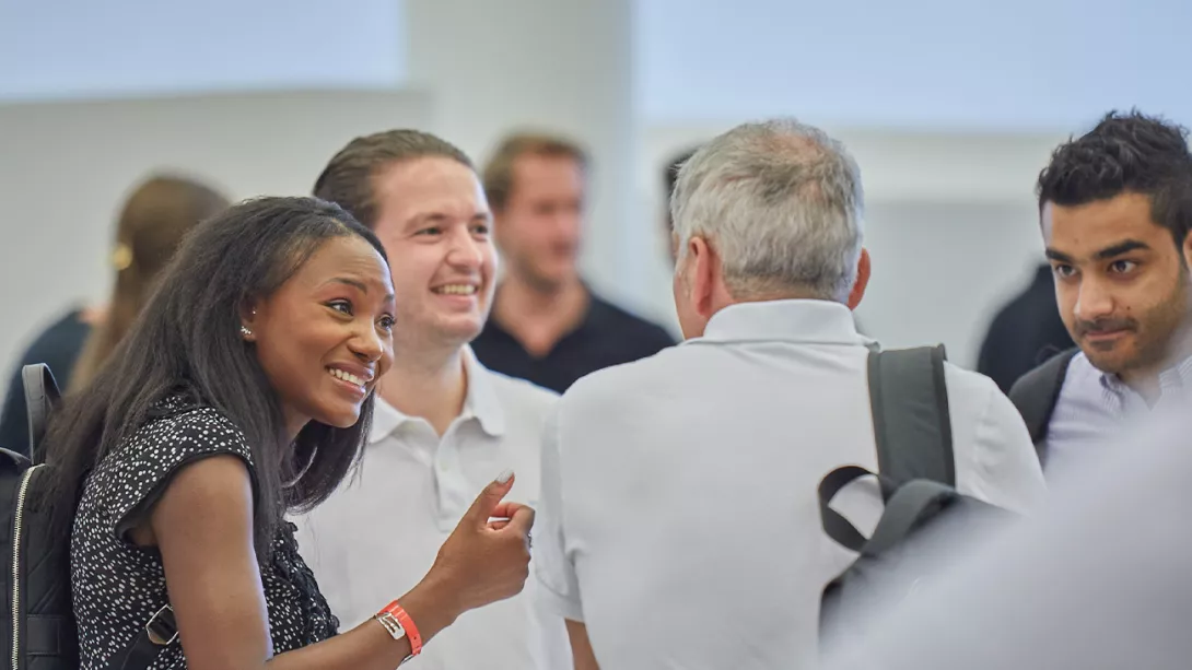 A group of two women and two men are talking animatedly to each other
